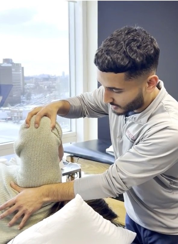 Dr. Abdul Siddiqui performing hands-on physical therapy with a patient